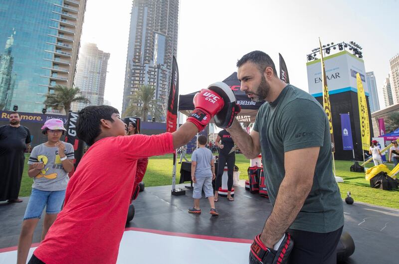 DUBAI, UNITED ARAB EMIRATES - A young boy practicing his boxing at the closing weekend carnival of the second year of the Dubai Fitness Challenge at Burj Park, Dubai.  Leslie Pableo for The National