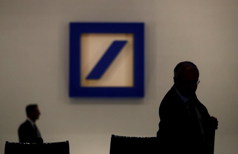 FILE PHOTO: Deutsche Bank's Supervisory Board Chairman Paul Achleitner is silhouetted next to the Deutsche Bank's logo prior to the bank's annual meeting in Frankfurt, Germany, May 24, 2018. REUTERS/Kai Pfaffenbach/File Photo