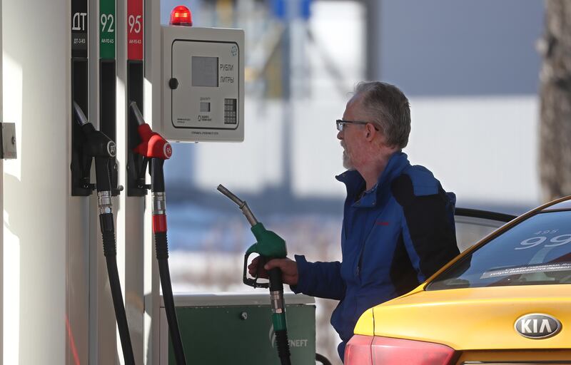 A man fills a car at a petrol station in Russia, which is demanding payment in roubles for its fossil fuels. EPA