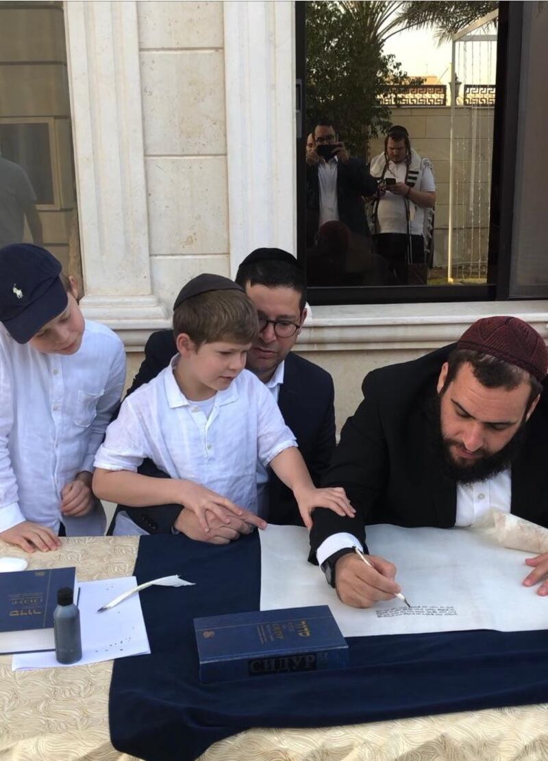 Rabbi Levi Duchman writes first letters in the Torah that was donated by a lady in Switzerland. Photo: Adina Krausz