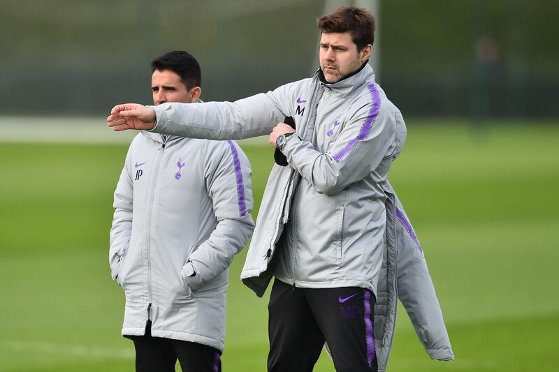 Tottenham Hotspur's Argentinian head coach Mauricio Pochettino (R) and assistant manager Jesus Perez (L) watch their players take part in a team training session at Tottenham Hotspur's Enfield Training Centre, north London, on February 12, 2019 on the eve of their UEFA Champions League round of 16 first leg football match against Dortmund. / AFP / Glyn KIRK                  
