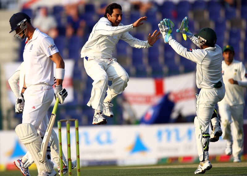 Abu Dhabi,  United Arab Emirates- January,  26, 2012: Pakistan bowler Saeed Ajmal (C) celebrates with his teamate  Adnan Akmal (R) after dismissing England batsman Kevin Pieterson(L) during the second Test match between Pakistan and England at Sheikh Zayed Stadium   in Abu Dhabi . (  Satish Kumar / The National ) For Sports