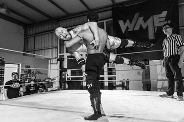 Cryptid lifts Sean Donn in the ring at Wrestling Middle East in Dubai. Antonie Robertson / The National