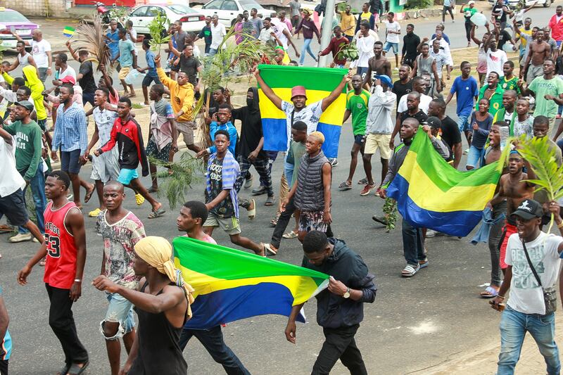 People celebrate in support of the coup in a street of Libreville. Reuters