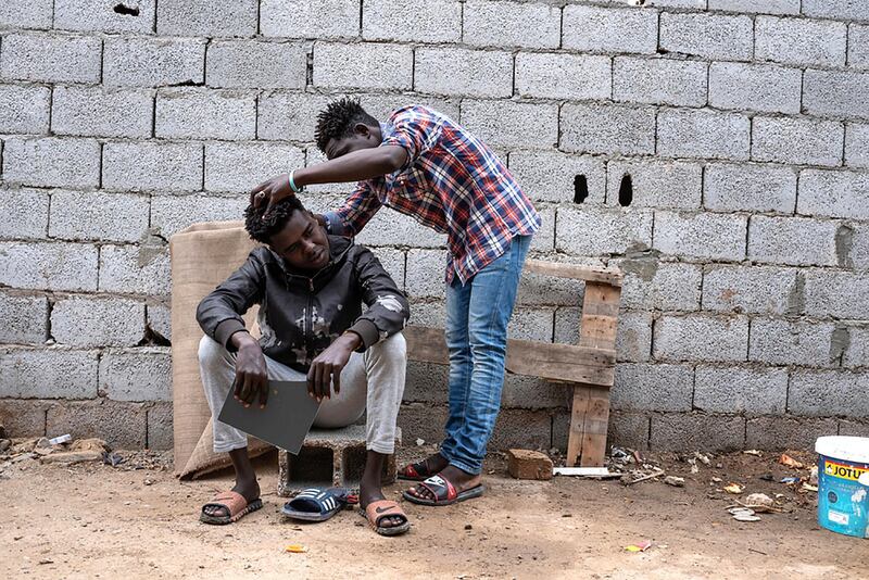 Refugees mostly from Darfur, Sudan are gathered in the courtyard where they live in Gorgi district, south of Tripoli. Migrants and refugees are often living in dire conditions, in dilapidated buildings or small unfinished houses, deprived of basic services.