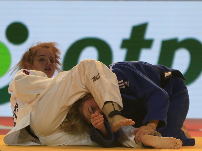 Kelly Staddon, in blue from Great Britain, fights with Nathalia Mercadante from Brazil on the opening day of the International Judo Federation (IJF) Junior World Championships, which started at the Ipic Arena at the Zayed Sports City in Abu Dhabi on Friday. Ravindranath K / The National