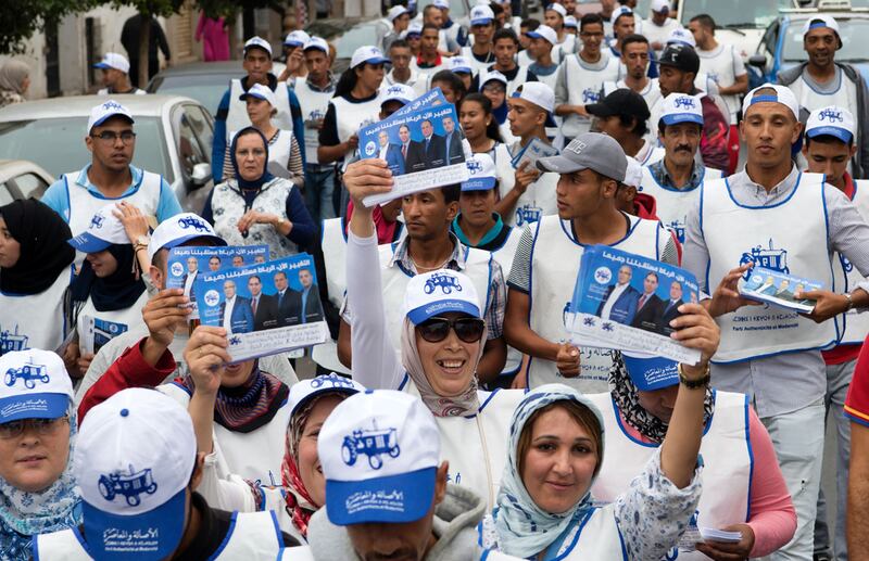 Supporters of Morocco's Party of Authenticity and Modernity (PAM) pass out campaign leaflets in the Moroccan capital , Rabat on October 5, 2016, ahead of the upcoming parliamentary election  on October 7. Fadel Senna / AFP 

