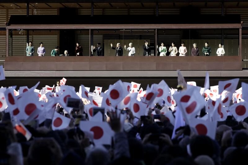 Emperor Akihito waves to members of the public during the New Year's appearance by the Japanese royal family at the Imperial Palace in Tokyo, Japan. Bloomberg