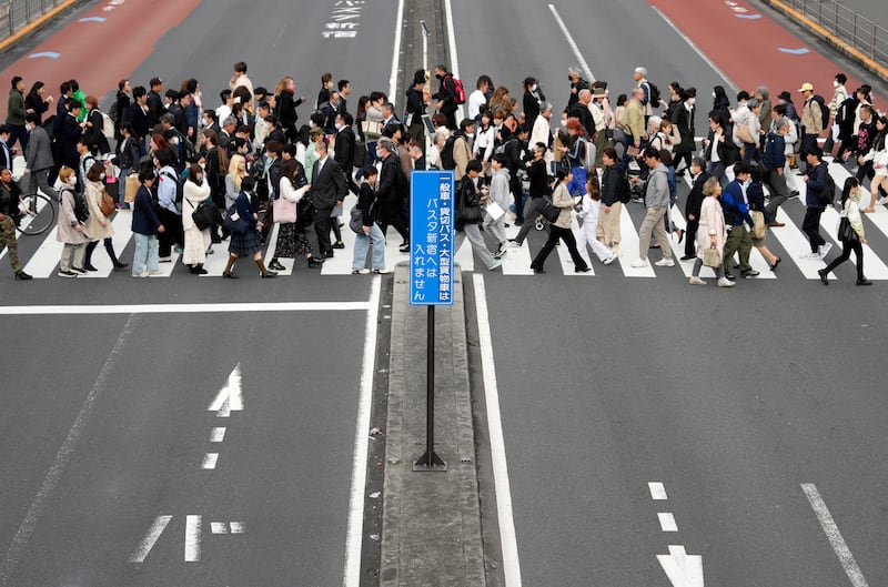 Pedestrians cross a wide street in the Shinjuku business and shopping district of Tokyo, Japan. EPA