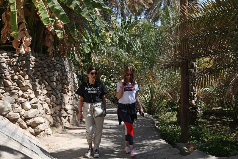 Omanis walk along a hiking trail in Misfat Al Abriyeen. AFP