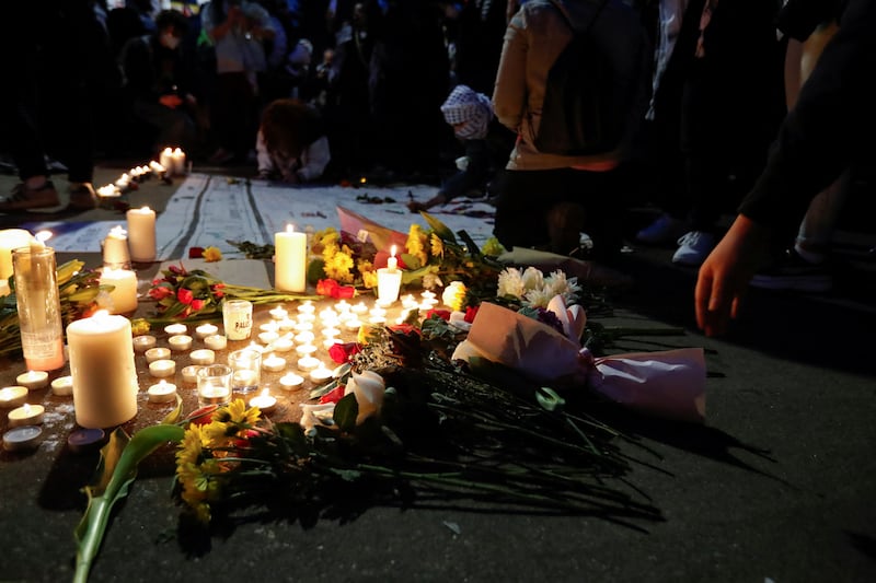 People leave flowers and notes at a memorial during the vigil for Mr Bushnell. Reuters