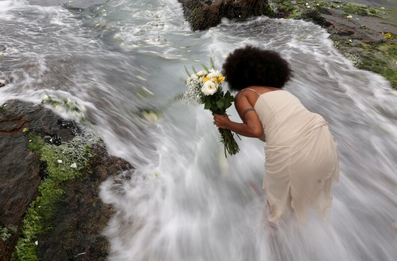 A woman pays tribute to the Afro-Brazilian goddess of the sea on Yemanja Day, at Arpoador Beach in Rio de Janeiro, Brazil. Reuters