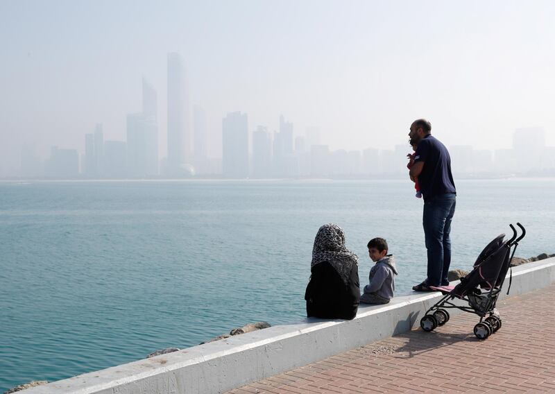 Abu Dhabi, U.A.E., February 8, 2018.  Fog at The Corniche UAE flag area.  A couple and their children enjoy the Abu Dhabi, sunny but chilly weather.  
Victor Besa / The National
National