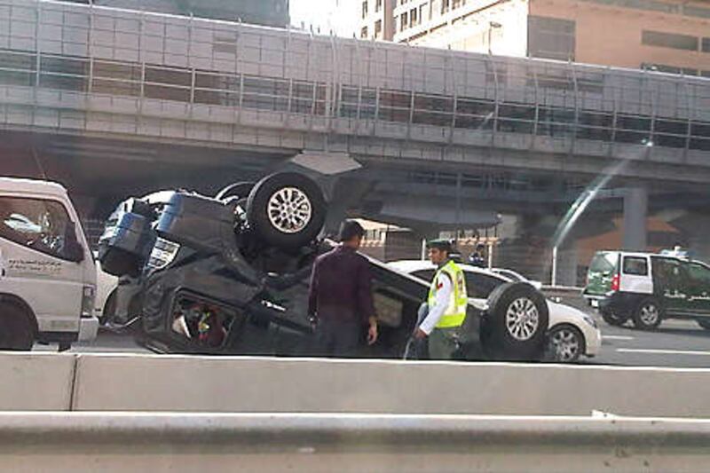 A car lies on its roof after four vehicles collided.