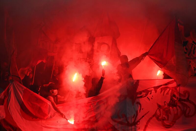 Brest's supporters light flares during the match. AP