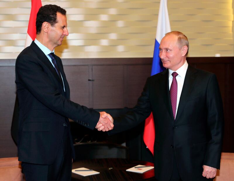 Russian President Vladimir Putin, right, shakes hands with Syrian President Bashar al-Assad during their meeting in the Black Sea resort of Sochi, Russia, Thursday, May 17, 2018. A transcript of Thursday's meeting released by the Kremlin quoted Assad as saying that Syria is making progress in fighting "terrorism," which "opens the door to the political process."  (Mikhail Klimentyev, Sputnik, Kremlin Pool Photo via AP)
