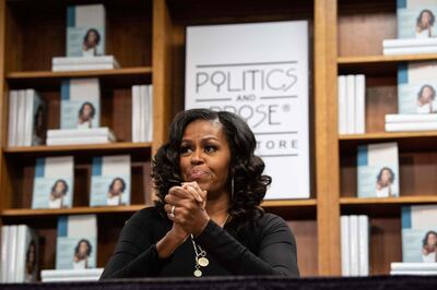 (FILES) In this file photo former US First Lady Michelle Obama meets with fans during a book signing on the first anniversary of the launch of her memoir "Becoming" at the Politics and Prose bookstore in Washington, DC, on November 18, 2019. Michelle Obama will star in a new documentary out next week which follows the former first lady's global book tour for her smash-hit memoir, Netflix said April 27, 2020. "Becoming," out May 6, is the Obamas' latest collaboration with the streaming giant after last year's "American Factory," which won the best documentary Oscar in February.
 / AFP / NICHOLAS KAMM
