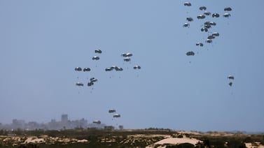 Humanitarian aid falls towards Gaza after being dropped from an aircraft. Reuters