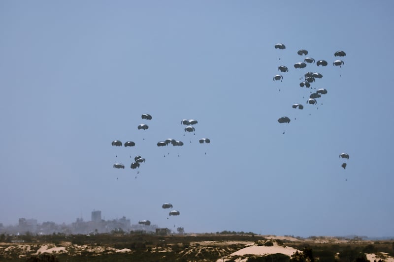 Humanitarian aid falls towards the Gaza Strip after being dropped from an aircraft. The conference aims to discuss how to get aid to those who need it the most. Reuters