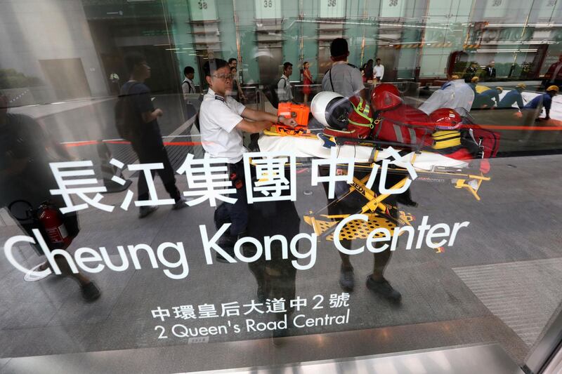 Medical team waits Robert at the Cheung Kong Center building. Reuters