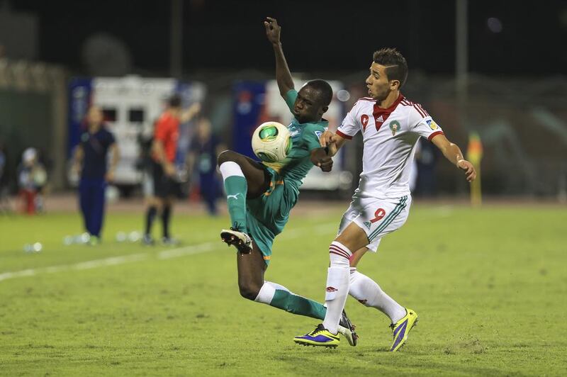 Ivory Coast player Ismael Diallo fights for the ball against Morocco’s Karim Achabar in Fujairah. Sarah Dea / The National