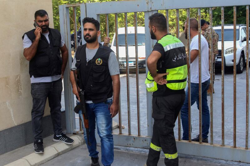 Members of Lebanon's security forces and emergency services arrive at a bank branch held up by an angry depositor demanding access to his savings in the southern city of Sour. AFP