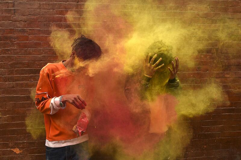 Revellers play with coloured powders as they celebrate Holi, the spring festival of colours, in Kathmandu. AFP