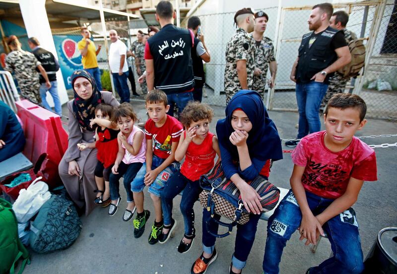 Syrian refugees gather as they prepare to leave the Lebanese capital Beirut, before their journey to return home to Syria on September 4, 2018. - A group of Syrian refugees left the Lebanese capital for their homeland on today as part of an organised operation coordinated between Lebanese and Syrian authorities. (Photo by ANWAR AMRO / AFP)