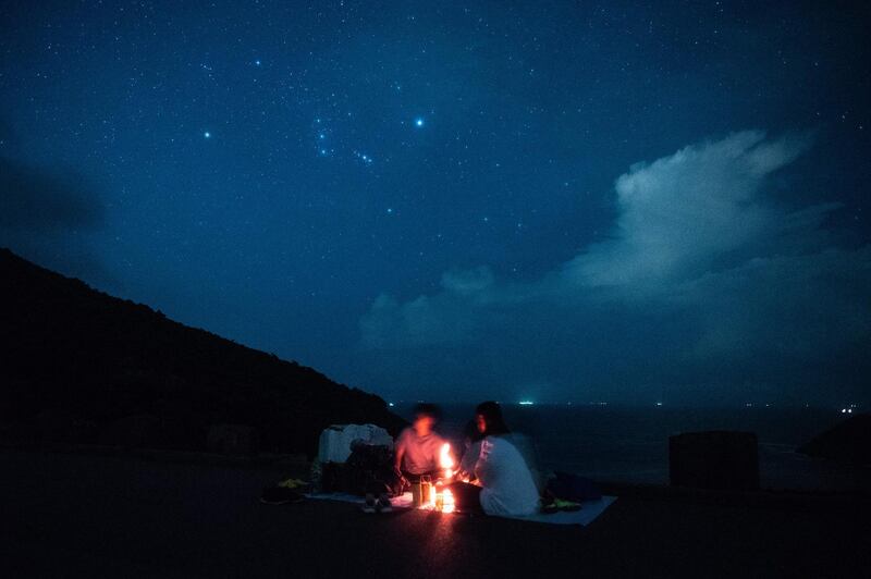 People wait to observe the annual Perseid meteor shower at the east dam of the High Island Reservoir in Hong Kong. AFP