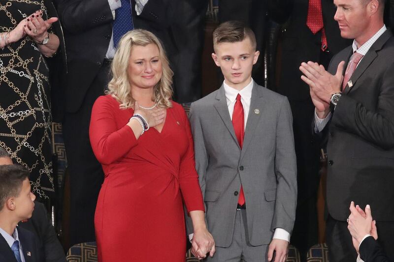 Kelli Hake, the widow of a US soldier killed in Iraq in 2008, atends the State of the Union address with her son, Gage Hake, in the chamber of the US House of Representatives in Washington, DC. Getty Images