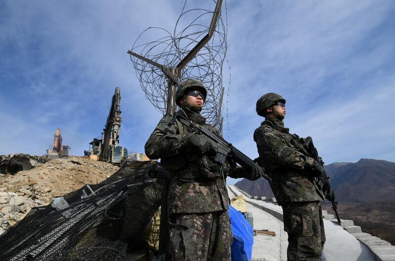 FILE PHOTO: South Korean soldiers stand guard as construction equipment destroy a guard post in the Demilitarized Zone dividing the two Koreas in Cheorwon on November 15, 2018.   Jung Yeon-je/Pool via Reuters/File Photo