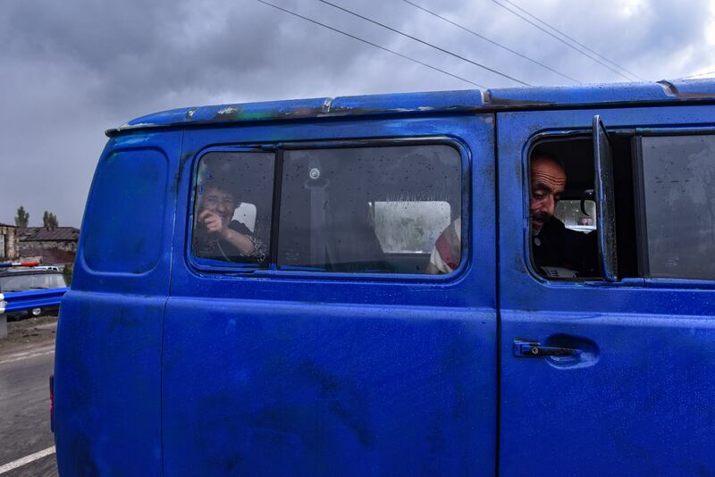 Ethnic Armenians from Nagorno-Karabakh look on from inside a van. EPA