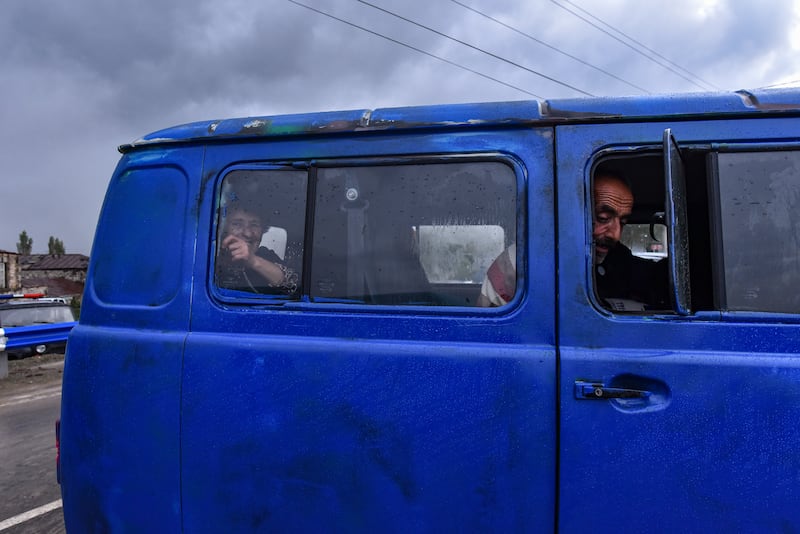 Ethnic Armenians from Nagorno-Karabakh look on from inside a van. EPA