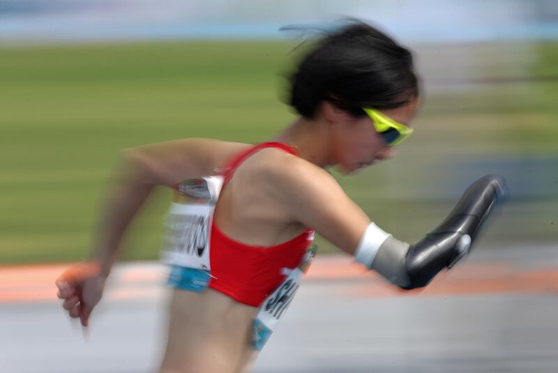 A photo taken using the panning effect shows Sae Shigemoto of Japan in action during the Women's 400m T47 at the World Para Athletics Championships in Dubai, United Arab Emirates.  EPA