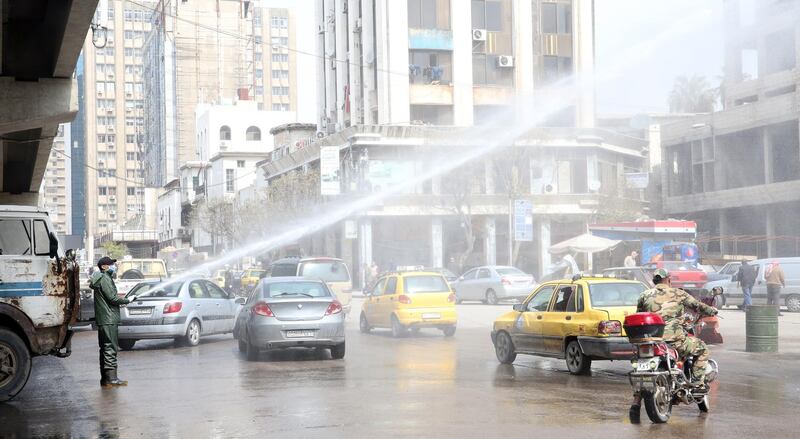 Workers sterilise the streets in Damscus, Syria. EPA
