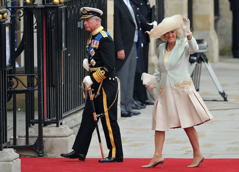 The queen consort, in a cream silk chiffon dress with a matching coat and a wide-brimmed straw hat by Philip Treacy, with King Charles at the wedding of Prince William and wife Katherine at Westminster Abbey on April 29, 2011. Getty Images