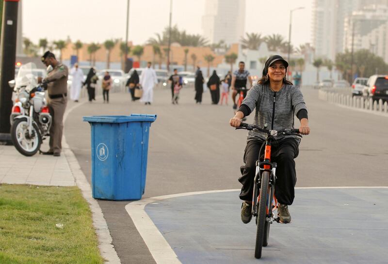 Eman Joharjy, a fashion designer in one of her own creations, cycles along Jaddah's Corniche, Saudi Arabia June 24, 2018. Picture taken June 24, 2018. REUTERS/Zohra Bensemra