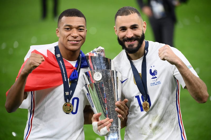 Kylian Mbappe and Karim Benzema with the trophy. AFP