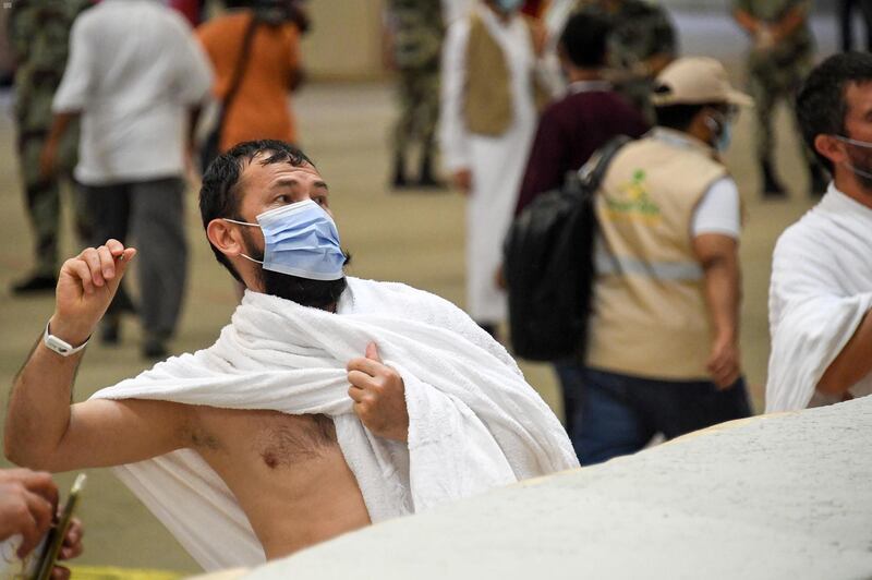 A Muslim pilgrim casts stones at pillars symbolising the devil in Mina. Saudi Press Agency / Reuters