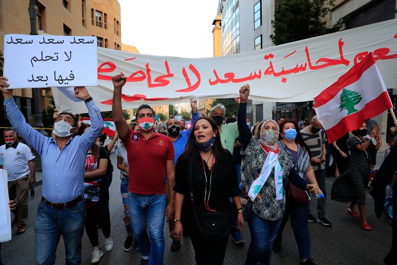 Anti-government protesters shout slogans during a protest to denounce the naming of former premier Saad Hariri as a potential candidate as the country's new prime minister, in downtown Beirut, Lebanon. AP Photo