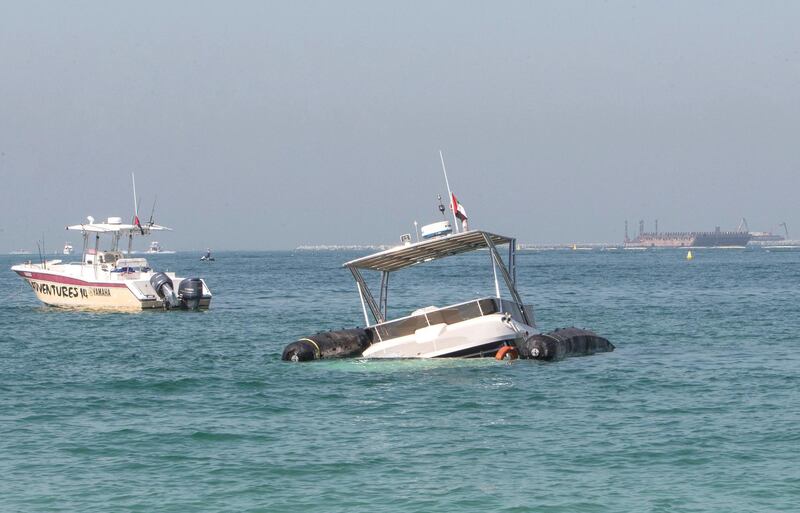 DUBAI, UNITED ARAB EMIRATES - A sunken yatch in front of Jumeirah Beach Residence with floaters on the side. Leslie Pableo for The National