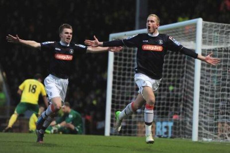 Luton's Scott Rendell, right, celebrates his goal against Norwich, a team five leagues above them. Jamie McDonald / Getty Images