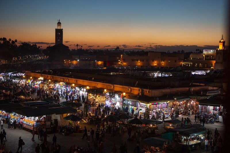 Market and stalls with city view in Marrakech at dusk, Morocco. Getty Images