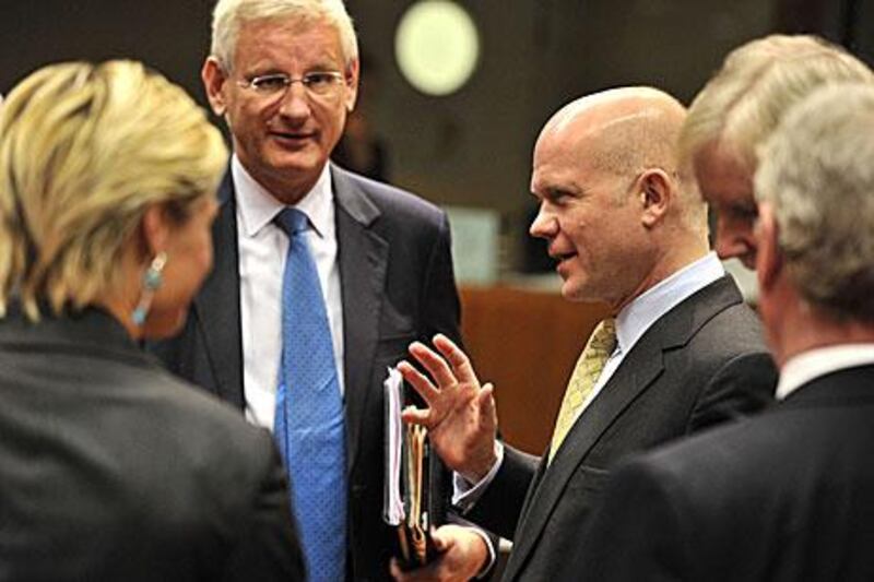 William Hague, the British foreign secretary, speaks with Carl Bildt, the Swedish foreign affairs minister, in Brussels. The 27-member EU agreed to enforce an oil embargo on Iran.