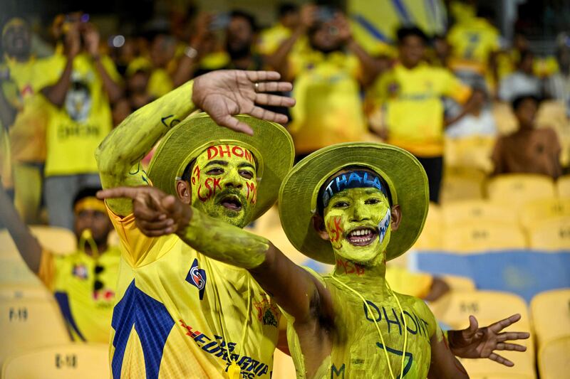 Fans of Chennai Super Kings' MS Dhoni cheer before the start of the match. AFP