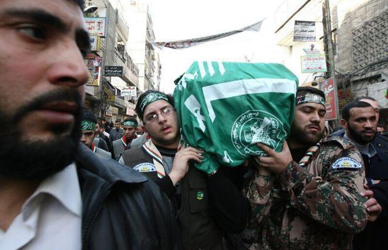 Mourners carry the Hamas flag-draped coffin of Mahmud al-Mabhuh, one of the founders of the Islamist movement's military wing, during his funeral procession at the Yarmuk refugee camp on the southern outskirts of the Syrian capital Damascus on January 29, 2010. Thousands of mourners took part in the funeral of the top militant in the Ezzedine al-Qassam Brigades which accused Israel of having assassinated him. Mabhuh, who was based in Syria, was 50 at the time of his death while on a trip to Dubai earlier this month.