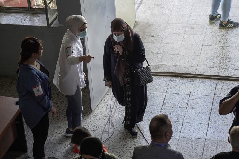 A woman makes her way to the polling station to cast her vote. Photo: Haider Husseini / The National