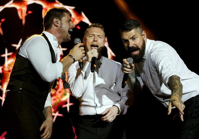 From left, Keith Duffy, Ronan Keating and Shane Lynch were the trio from Boyzone who took to the stage at the Dubai Tennis Stadium. Satish Kumar / The National