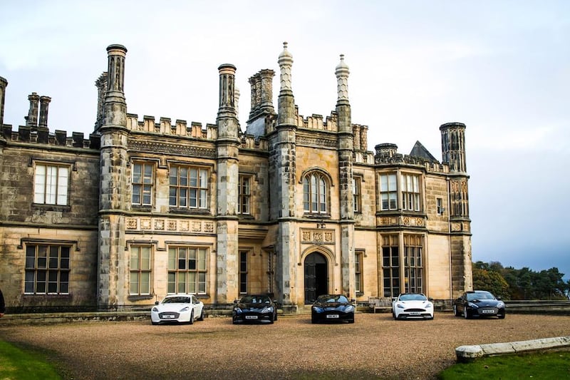 Aston Martin cars in front of Dalmeny House, a stately Tudor Gothic property on the banks of the Firth of Forth. Danielle Booth / Motif Productions