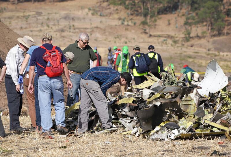 Investigators with the NTSB look over debris at the crash site. Getty Images